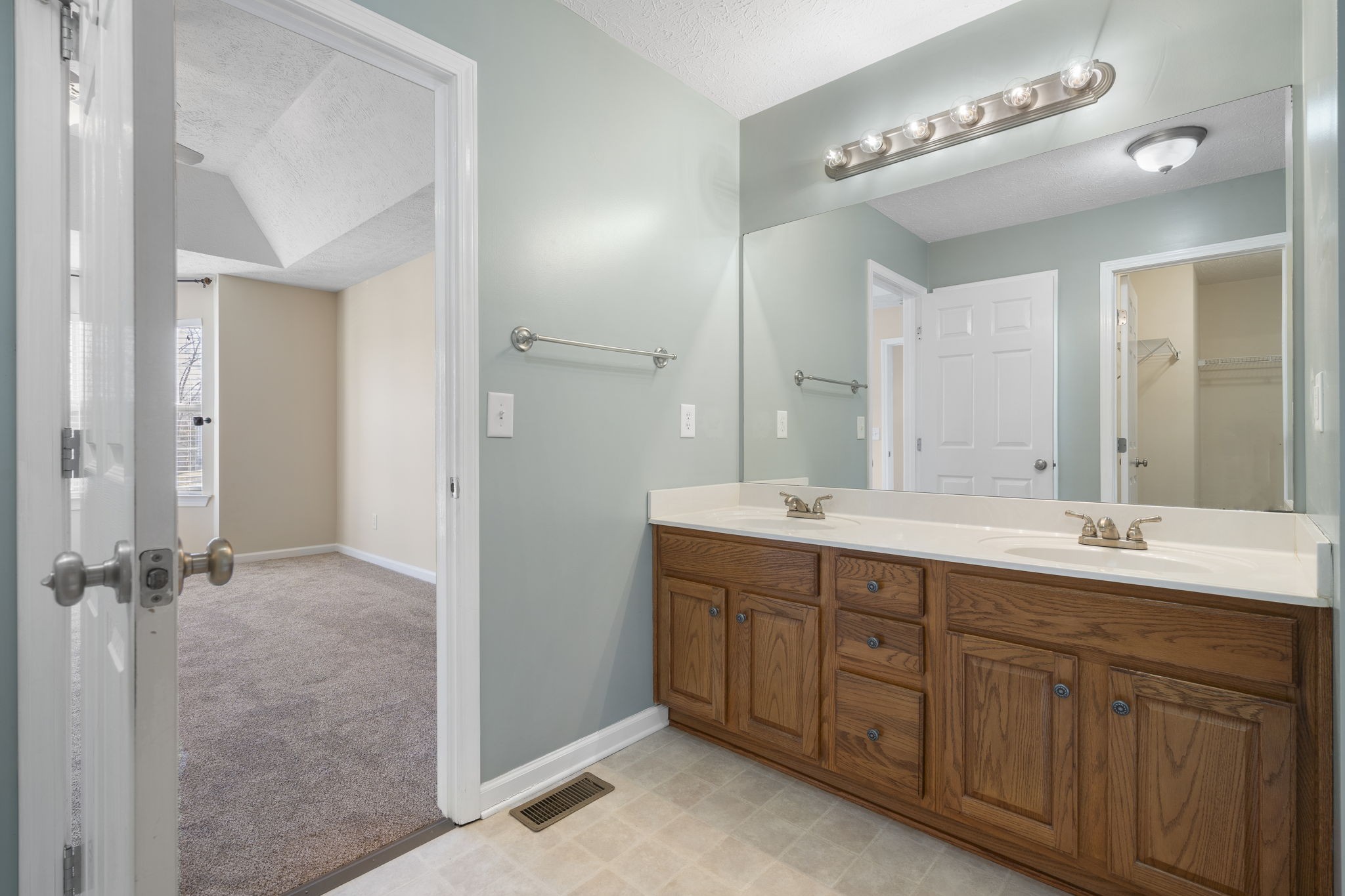 4244 Birmingham Road Lebanon, TN 37090 - Photo 25 of 40 a bathroom with a double vanity sink and mirror
