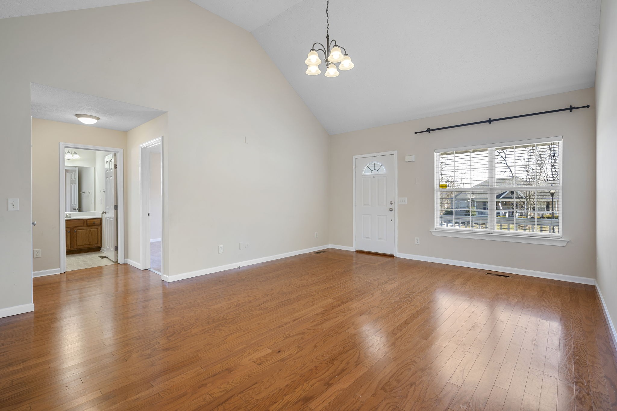 4244 Birmingham Road Lebanon, TN 37090 - Photo 9 of 40 an empty room with wooden floor chandelier and windows