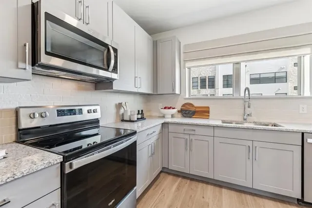 a kitchen with a stove microwave and sink