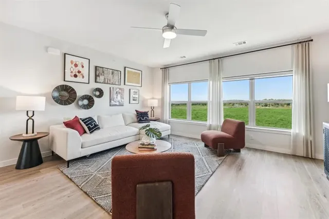 a living room with furniture and a large window