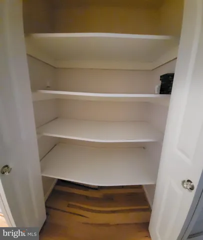 a kitchen with stainless steel appliances a refrigerator a sink a stove and white cabinets