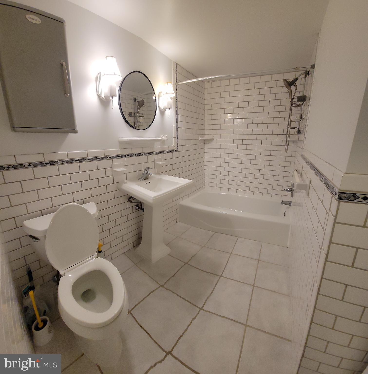 46 Township Line Road, Unit 305 Elkins Park, PA 19027 - Photo 19 of 31 a bathroom with a toilet a sink and a shower