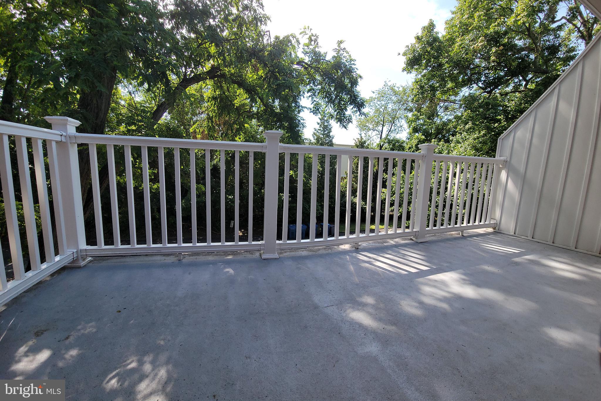 46 Township Line Road, Unit 305 Elkins Park, PA 19027 - Photo 20 of 31 a view of a backyard with wooden fence and trees