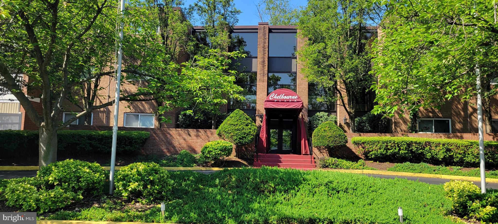 46 Township Line Road, Unit 305 Elkins Park, PA 19027 - Photo 2 of 31 a front view of a house with a yard and fountain