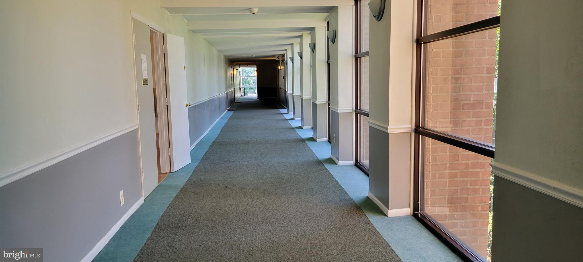 46 Township Line Road, Unit 305 Elkins Park, PA 19027 - Photo 21 of 31 a view of a hallway with a wooden door