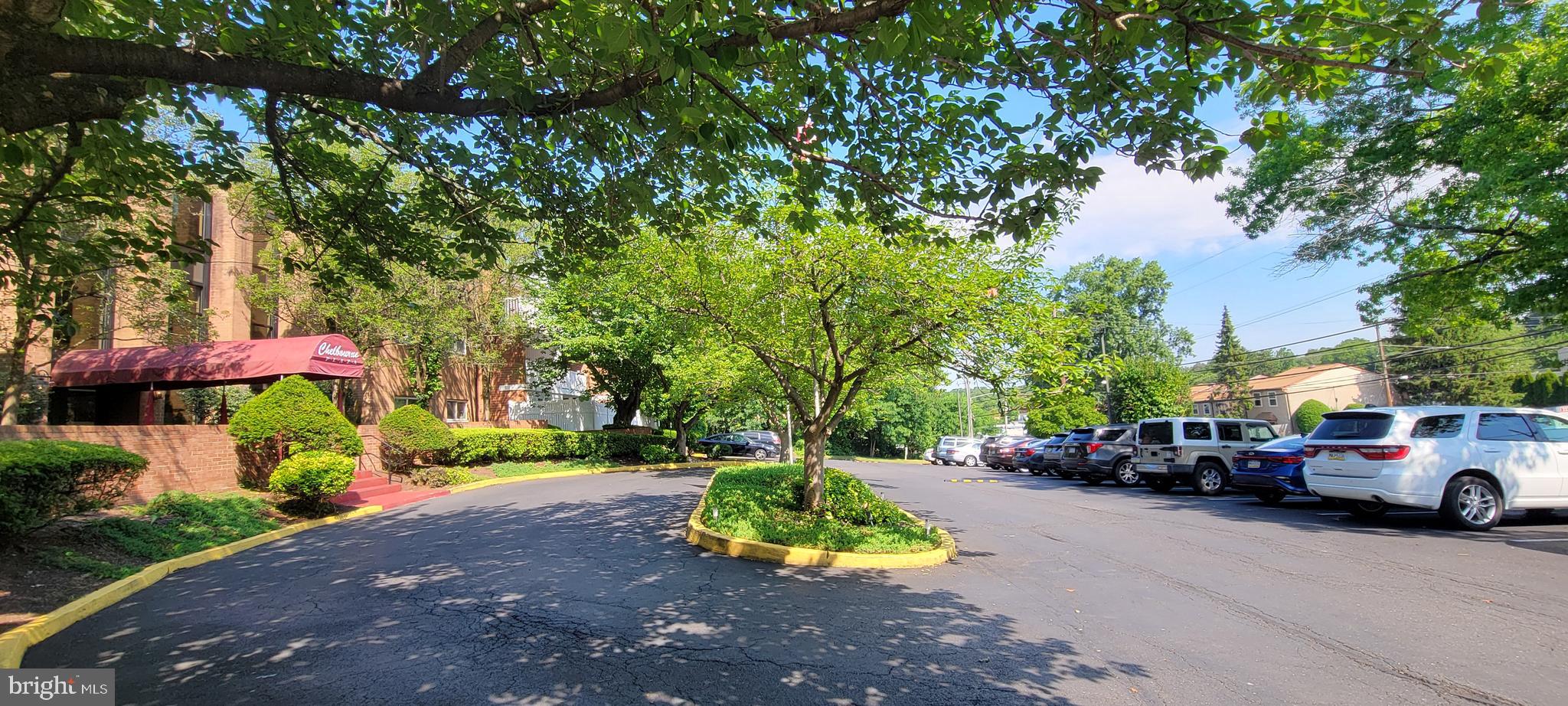 46 Township Line Road, Unit 305 Elkins Park, PA 19027 - Photo 23 of 31 a view of road with card parked on side and retail shops