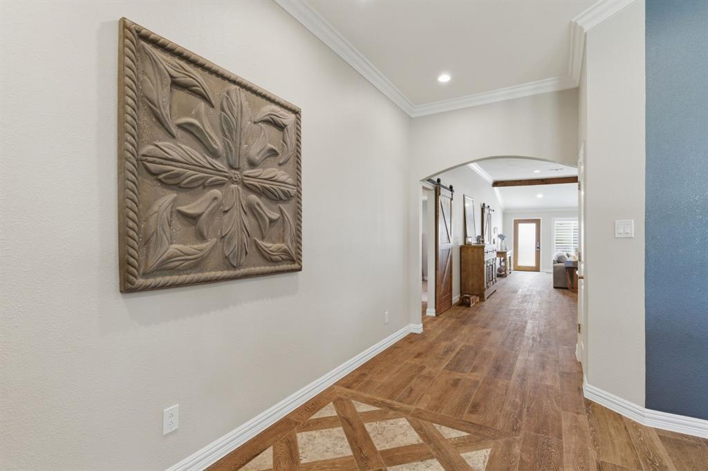 10390 Ridgecrest Street Frisco, TX 75033 - Photo 13 of 40 a view of a hallway with wooden floor and a bathroom