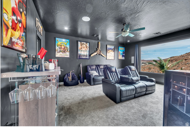 6105 Bunda Way St. George, UT 84790 - Photo 23 of 49 Dedicated media room featuring recessed lighting, a ceiling fan, a large picture window, and light gray carpeting
