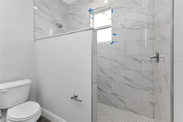 a white toilet sitting next to a bathroom