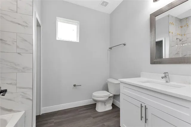 a bathroom with a sink a toilet and a mirror