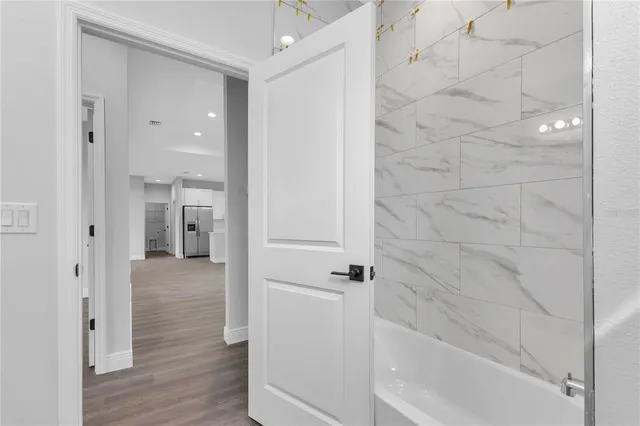 a bathroom with a bathtub and shower