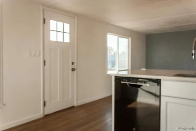 a kitchen with a sink window and cabinets