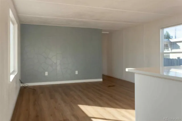 a view of wooden floor and windows in a room
