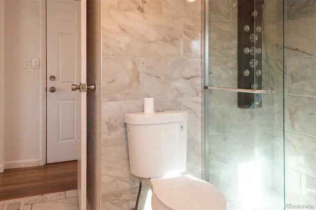 a bathroom with a toilet and a shower