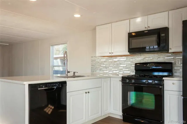 a kitchen with a sink stove and microwave
