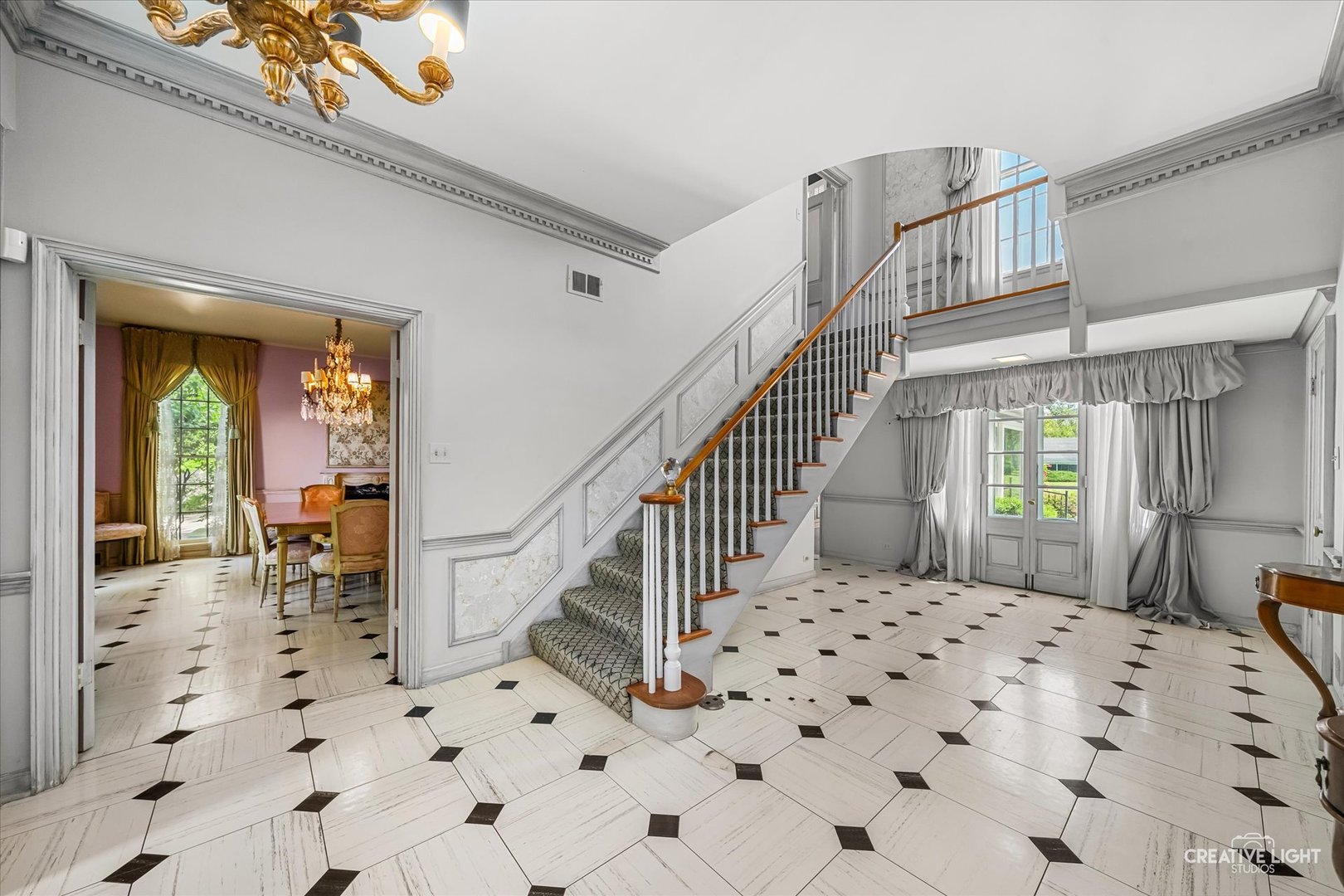 33W451 Surrey Road Wayne, IL 60184 - Photo 20 of 41 a view of a hallway with dining area and chandelier