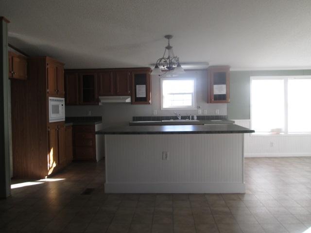 837 Summitt Ridge Drive Blue Ridge, VA 24064 - Photo 8 of 29 a kitchen with kitchen island granite countertop a sink window and refrigerator
