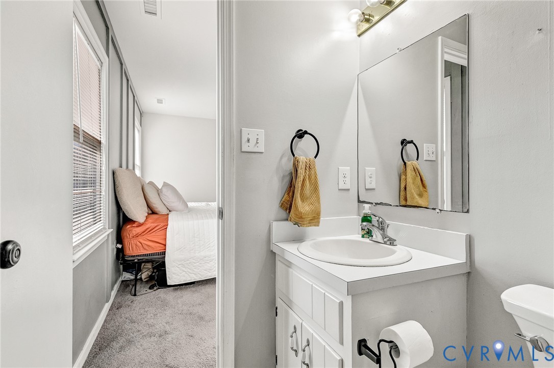 6377 Sledds Lake Road Mechanicsville, VA 23111 - Photo 12 of 15 a bathroom with a sink and a mirror