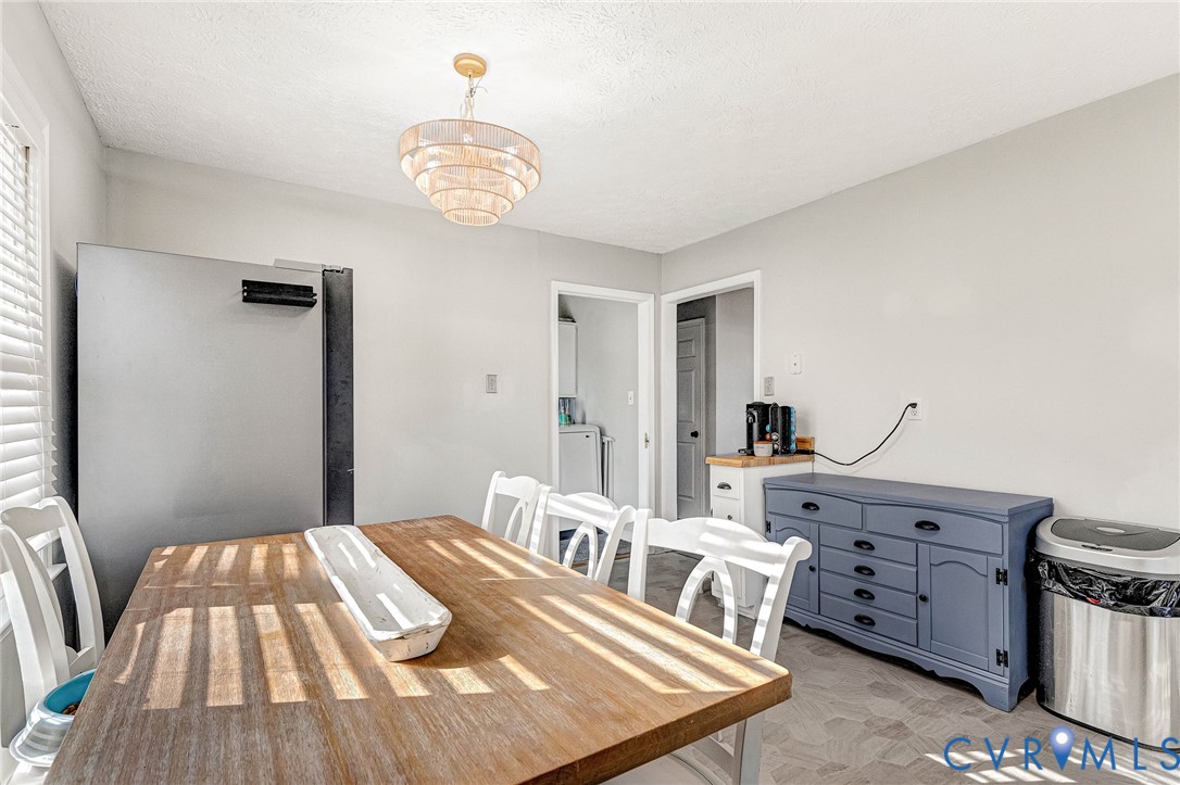 6377 Sledds Lake Road Mechanicsville, VA 23111 - Photo 7 of 15 a bedroom with a bed and a chandelier