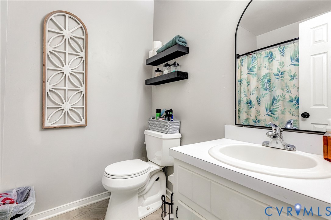 6377 Sledds Lake Road Mechanicsville, VA 23111 - Photo 9 of 15 a bathroom with a toilet a sink and mirror