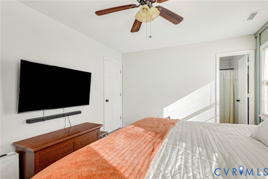 6377 Sledds Lake Road Mechanicsville, VA 23111 - Photo 10 of 15 a bedroom with a bed and a flat screen tv