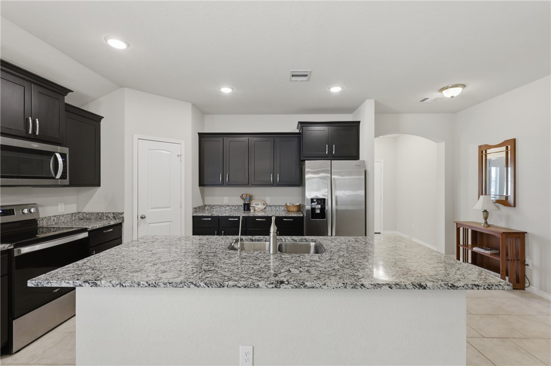1943 Thorndyke Lane Bryan, TX 77807 - Photo 7 of 28 Large kitchen with counter space for prepping food, entertaining on the island and stainless steel appliances
