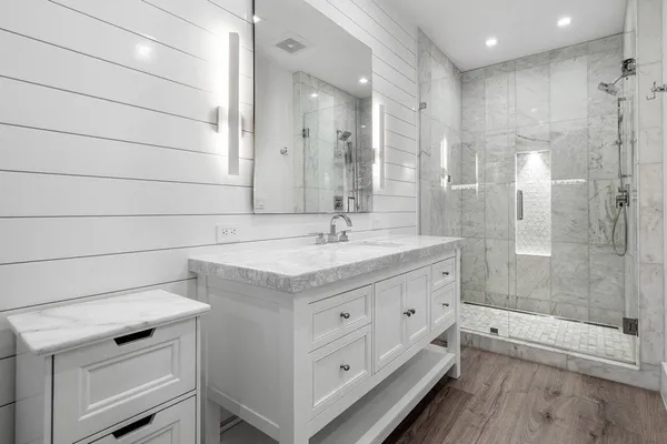 a bathroom with a sink a toilet and a mirror