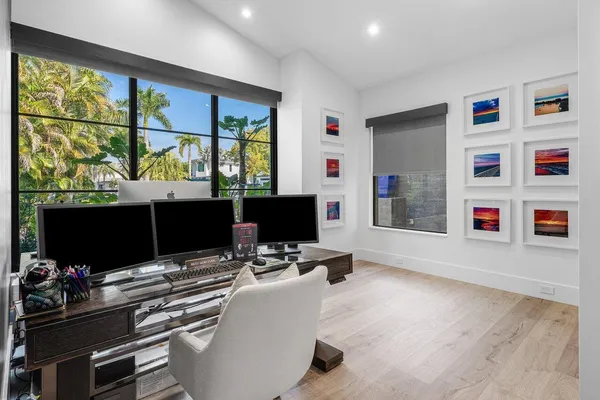 a bedroom with a large bed and a large window