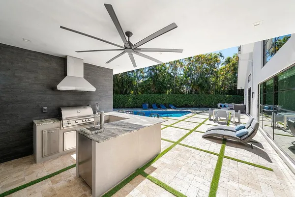 a front view of multi story residential apartment building with yard and sign board