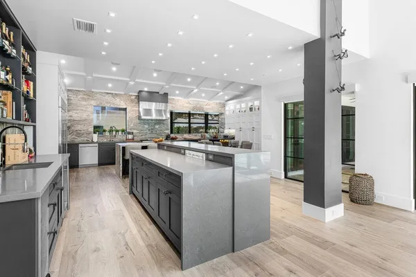 a dining room with stainless steel appliances kitchen island a table and chairs