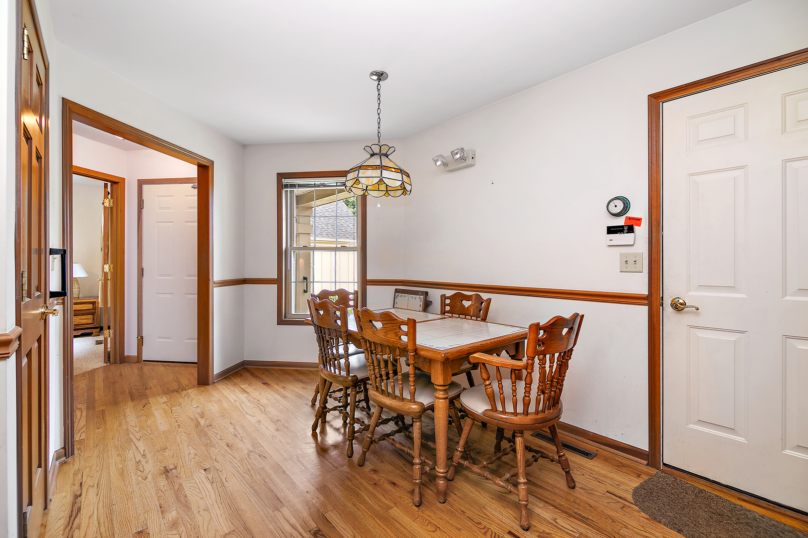 548 Olde Oak Drive, Unit 548 Bourbonnais, IL 60914 - Photo 12 of 26 a view of a dining room with furniture window and wooden floor