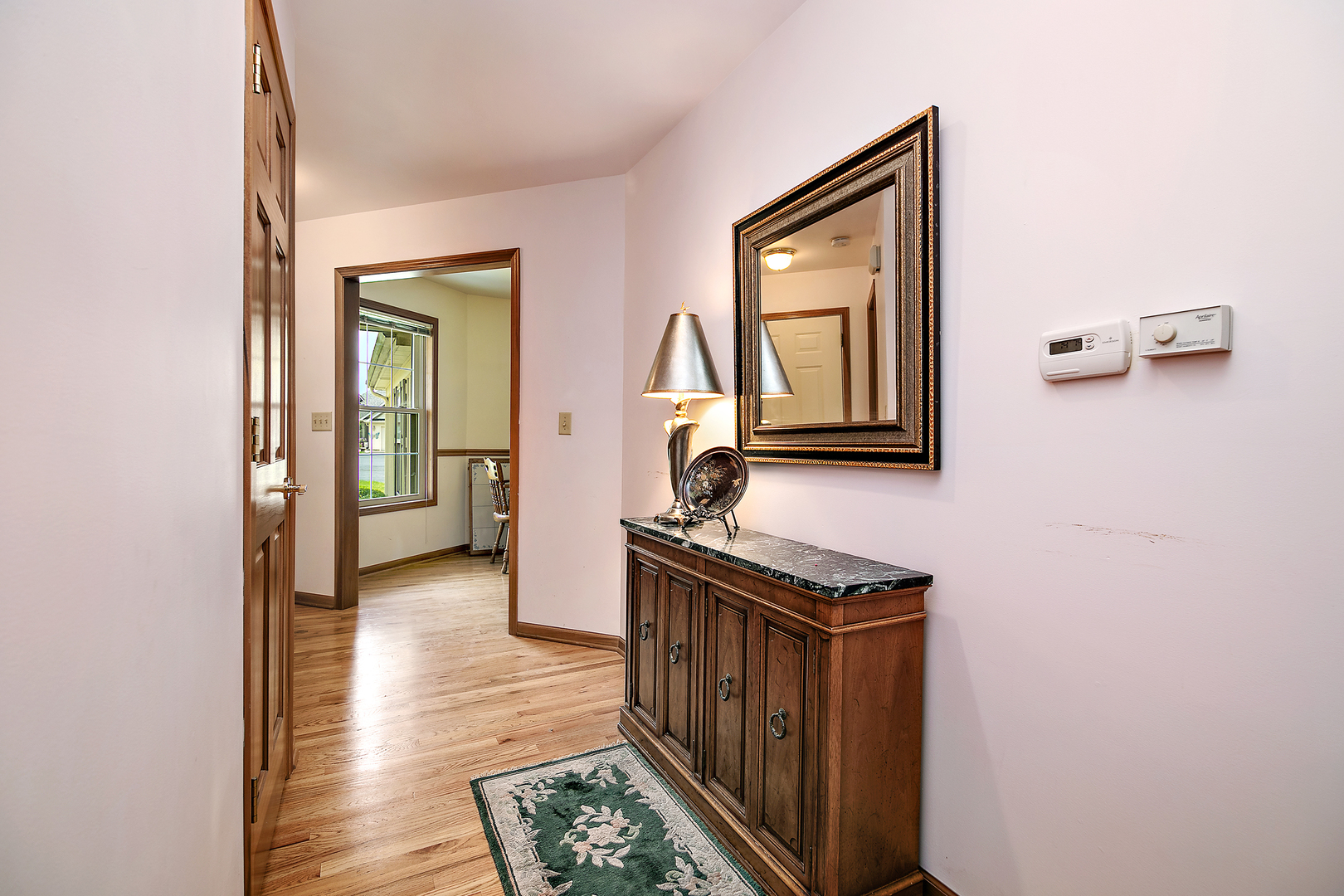 548 Olde Oak Drive, Unit 548 Bourbonnais, IL 60914 - Photo 3 of 26 a view of hallway with a mirror and furniture
