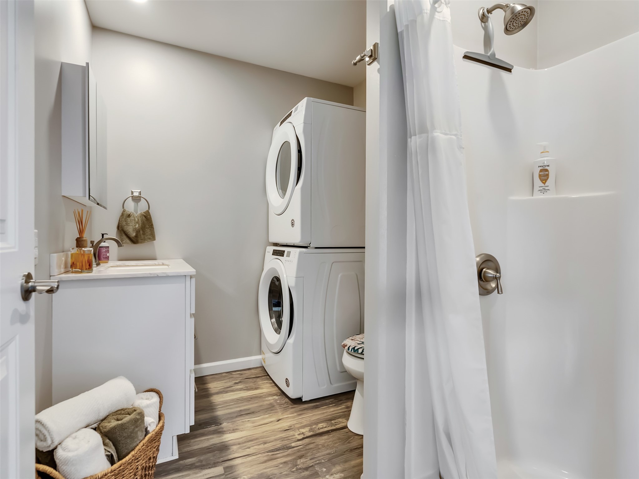 1453 County Road 230 Sargent, TX 77414 - Photo 19 of 38 Guest Bath — Conveniently designed with a full shower, vanity, and in-unit laundry area, this well-appointed guest bathroom offers both comfort and functionality for family and visitors