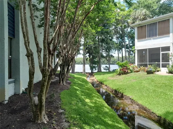 a view of a lake with houses in the back