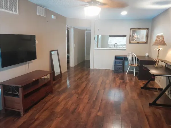 a kitchen with a sink cabinets and wooden floor