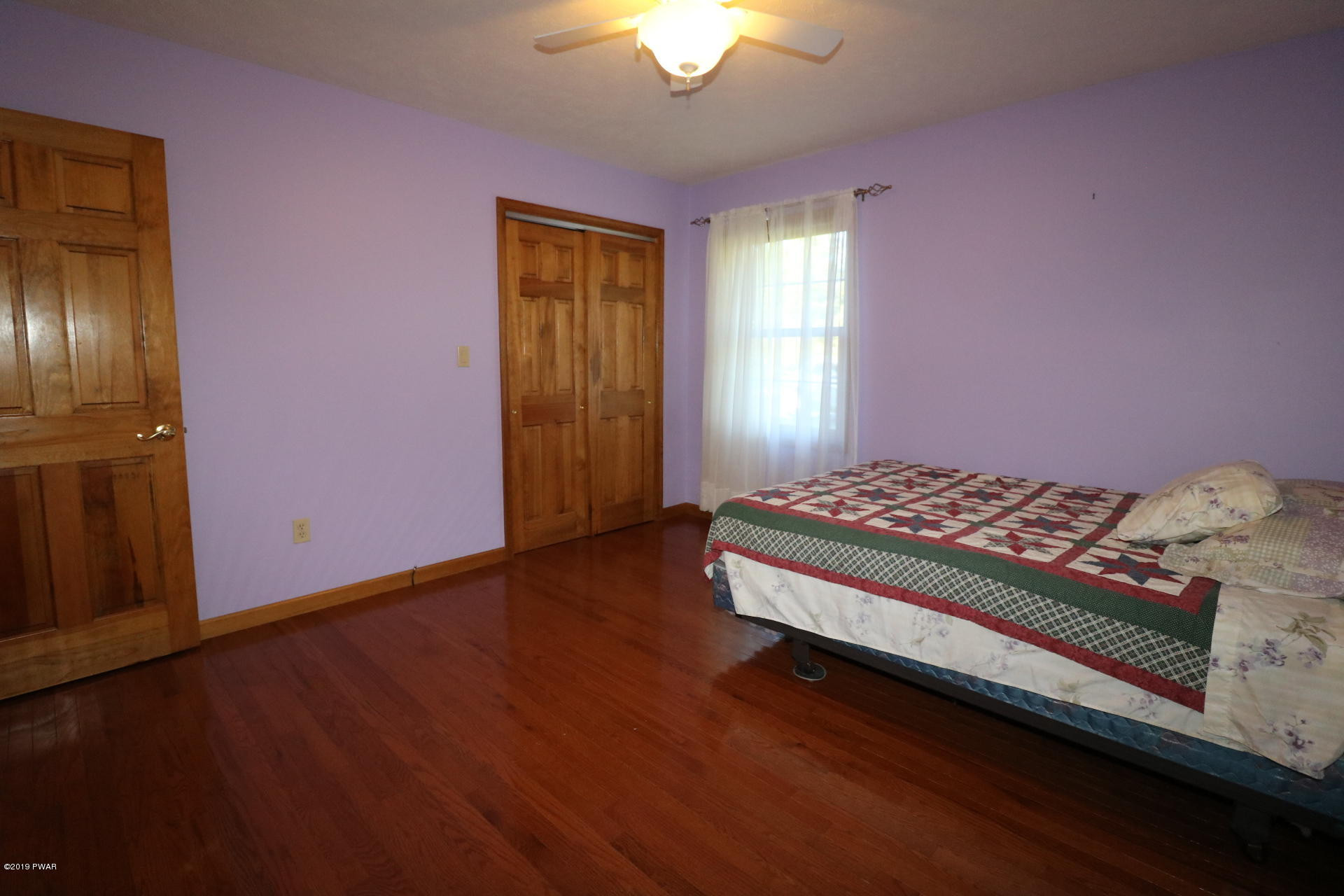 53 Savitz Road Lake Ariel, PA 18436 - Photo 41 of 53 a bedroom with a bed and a chandelier