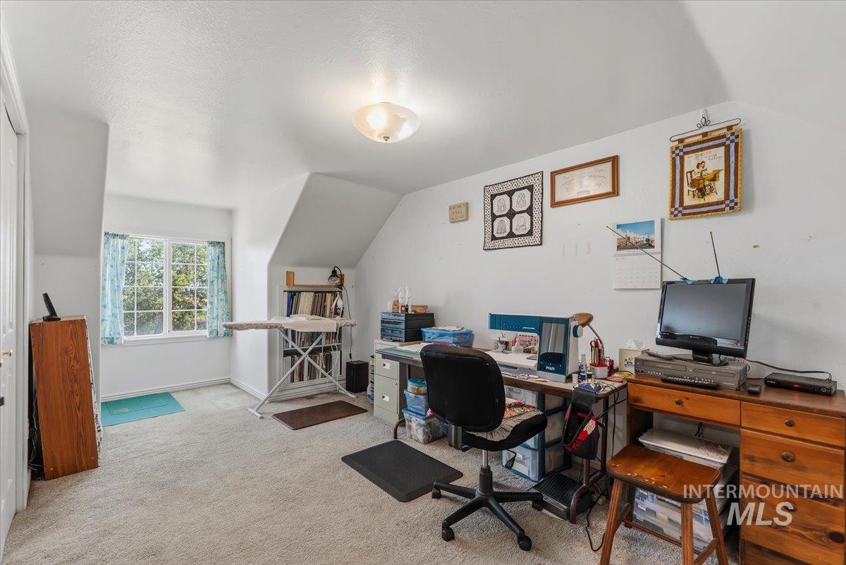 2331 Gulley Road Homedale, ID 83628 - Photo 26 of 46 Carpeted room featuring a double-paned window, sloped ceilings, and a flush-mount ceiling light fixture
