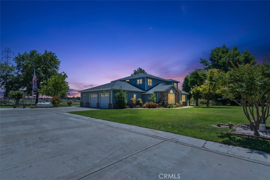 3856 North Gardner Avenue Merced, CA 95340 - Photo 1 of 59 a front view of a house with a yard and garage