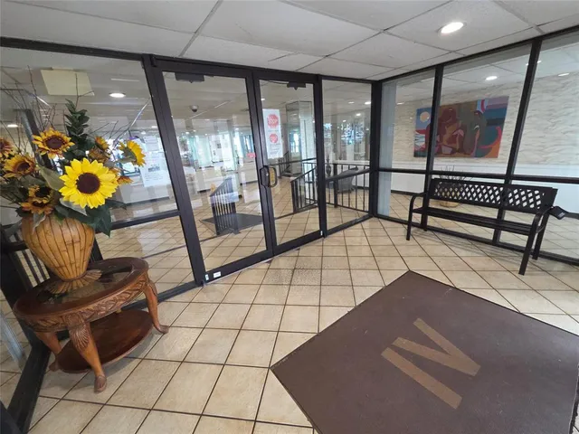 a living room with furniture and floor to ceiling window