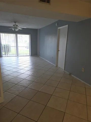 a view of a livingroom with wooden floor and a window