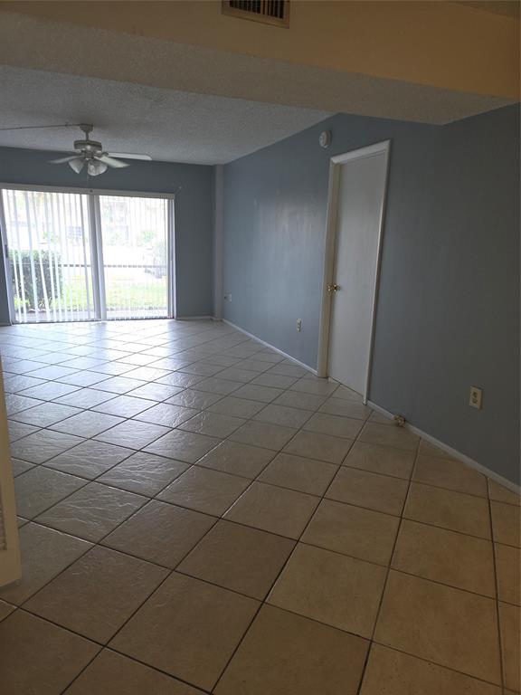 4158 Inverrary Drive, Unit 104 Lauderhill, FL 33319 - Photo 11 of 40 a view of a livingroom with wooden floor and a window
