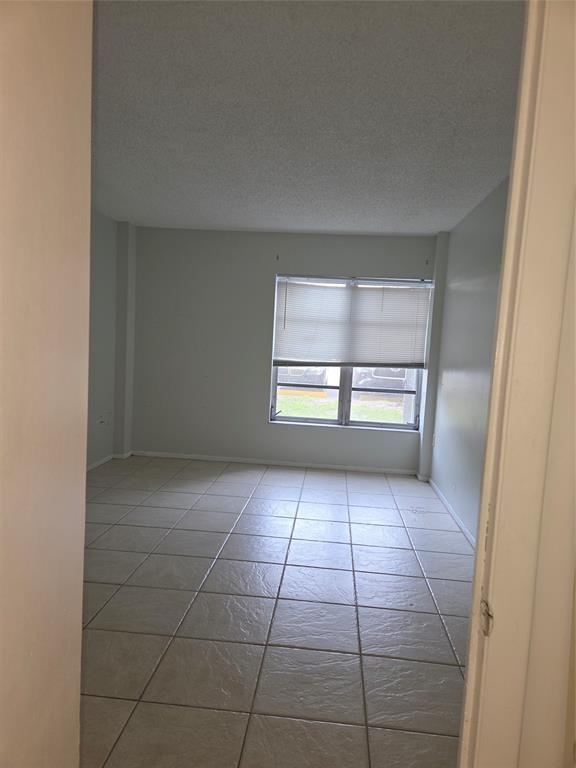 4158 Inverrary Drive, Unit 104 Lauderhill, FL 33319 - Photo 14 of 40 wooden floor in an empty room with a window