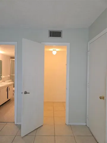 a view of a hallway to rooms