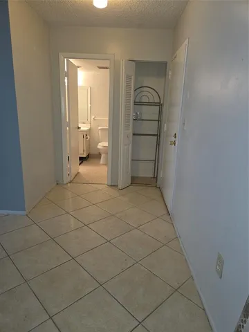 a view of a closet area with ceiling fan