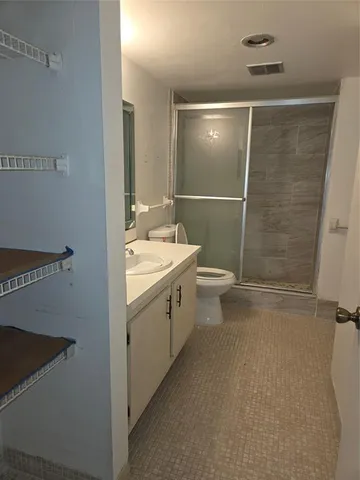 a bathroom with a double vanity sink toilet and shower