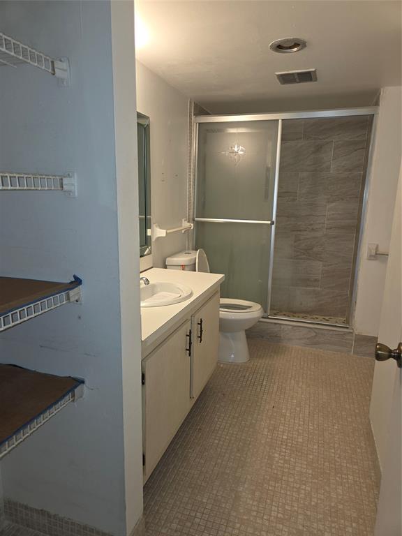 4158 Inverrary Drive, Unit 104 Lauderhill, FL 33319 - Photo 25 of 40 a bathroom with a double vanity sink toilet and shower