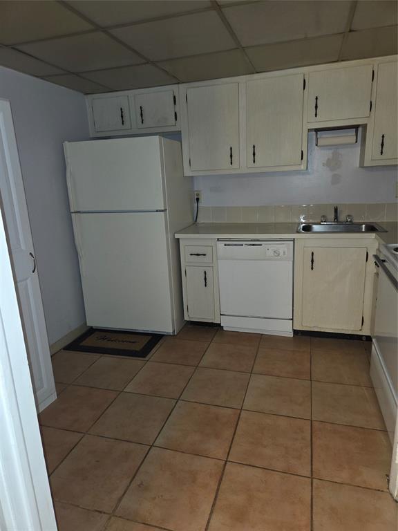 4158 Inverrary Drive, Unit 104 Lauderhill, FL 33319 - Photo 30 of 40 a kitchen with a stove a refrigerator and white cabinets