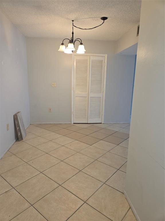 4158 Inverrary Drive, Unit 104 Lauderhill, FL 33319 - Photo 33 of 40 a view of a livingroom with a chandelier fan and glass door