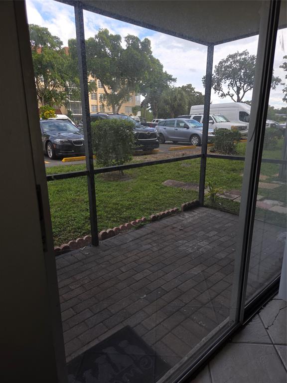 4158 Inverrary Drive, Unit 104 Lauderhill, FL 33319 - Photo 40 of 40 a view of a porch with a table & chairs