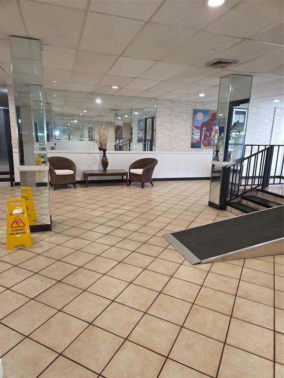 4158 Inverrary Drive, Unit 104 Lauderhill, FL 33319 - Photo 4 of 40 a living room with lots of furniture and a flat screen tv